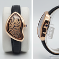 Asymmetric rose gold skeleton dial watch with black strap front and side view