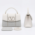 White and silver-grey herringbone handbag front and side views with matching pouch and strap