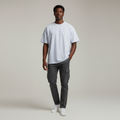 Young Nigerian male wearing light grey-blue oversized plain crew neck tee