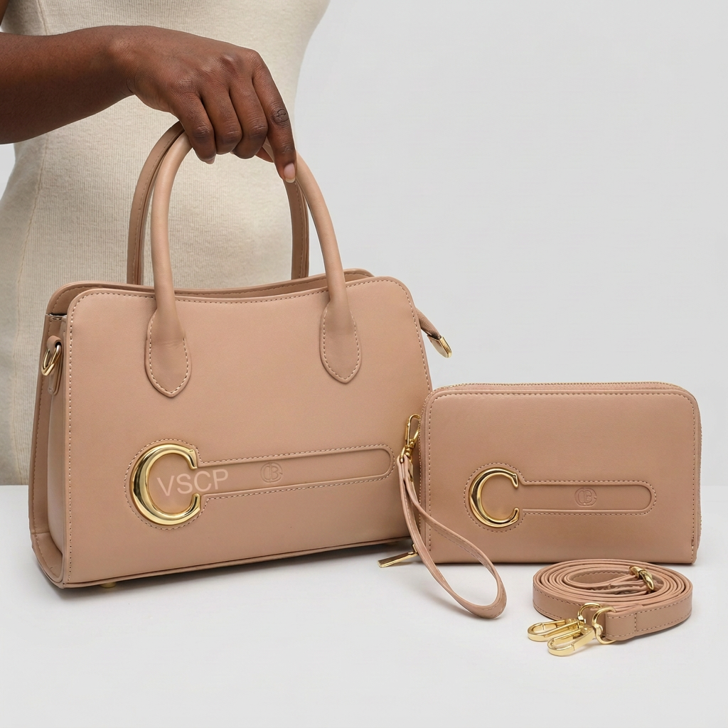 Hand holding beige handbag with matching wristlet and strap, without hanging label