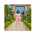 Nigerian female model wearing blush pink tracksuit co-ord set with white side stripes