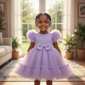 Young Nigerian baby girl wearing purple puff sleeve tulle dress