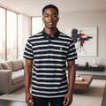 Young Nigerian male model wearing black and grey stripe polo shirt, front view