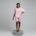 Nigerian female model front view - pink cascading rhinestone top and shorts set