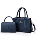 Navy patterned tote and matching flap handbag on white background