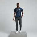 Nigerian male model wearing black blue baroque swirl football jersey on concrete plinth