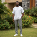 Nigerian male model wearing grey plaid check trousers in outdoor setting