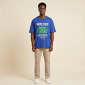 Model wearing cobalt blue globe graphic T-shirt
