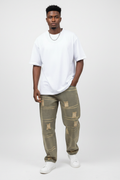 Nigerian model wearing olive washed graphic baggy distressed jeans, front view