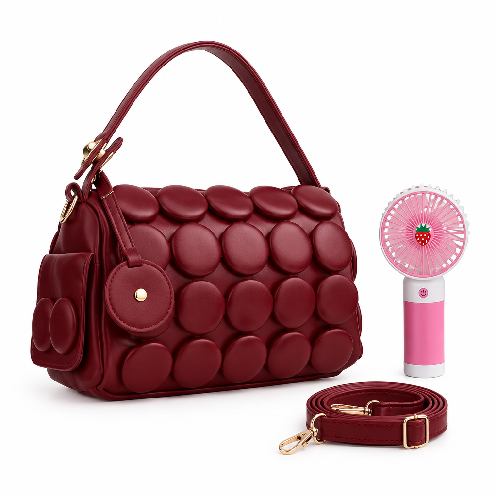 Burgundy circle-appliqué shoulder bag with matching strap and pink handheld fan on white background