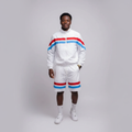 Model wearing the white jacket and shorts set with red and blue stripes