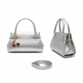 Silver metallic leather mini handbag ghost mannequin front and side view with red cherry charm and crossbody strap