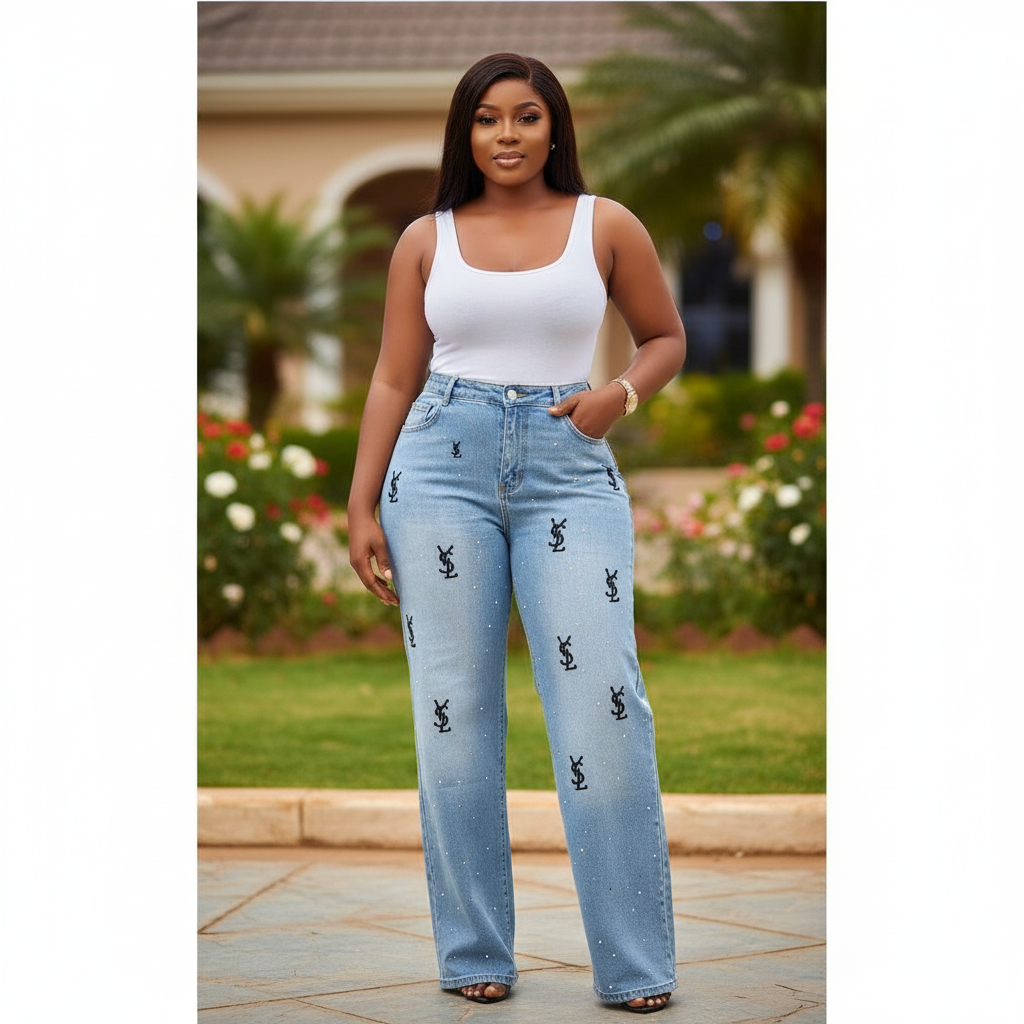 Nigerian female model wearing light blue monogram print wide leg denim jeans in garden setting