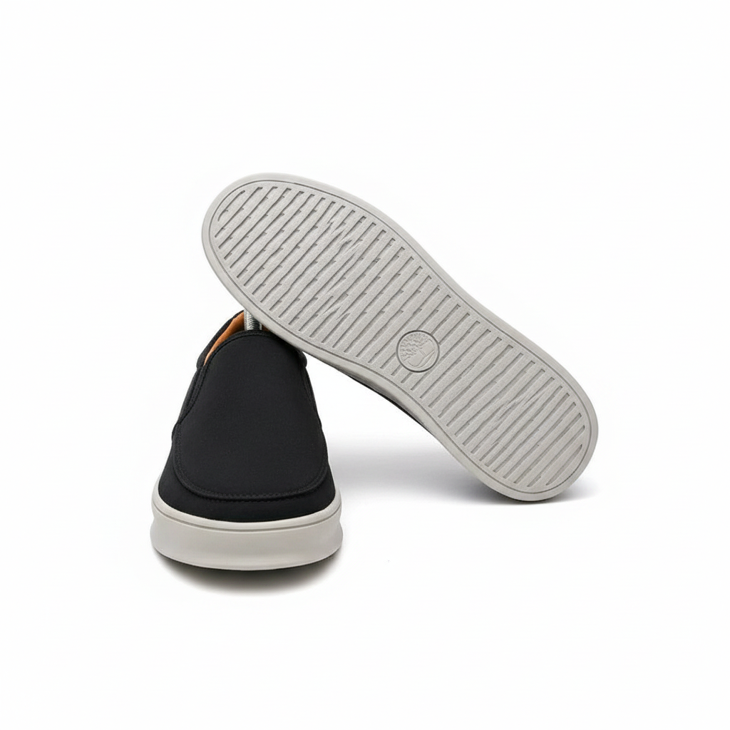 Men's black suede slip-on sneakers ghost mannequin front and sole view