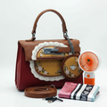 Reddish-brown floral handbag, round pouch, mini fan, strap, scarf and cable on white
