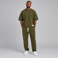 Nigerian male model wearing olive oversized t-shirt and jogger tracksuit set