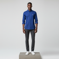 Nigerian male model wearing cobalt blue plain long-sleeved shirt, front view