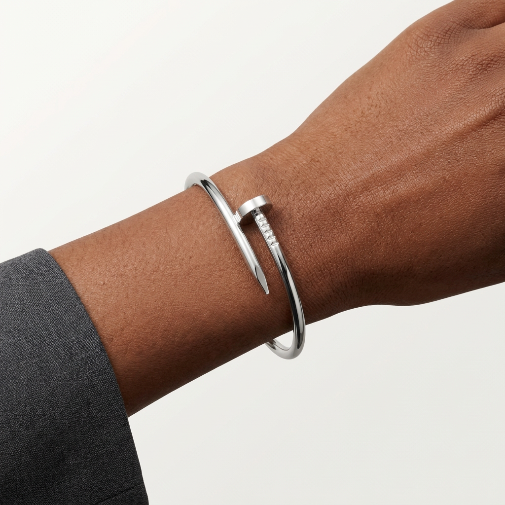 Silver-tone nail-style bracelet worn on a model’s wrist