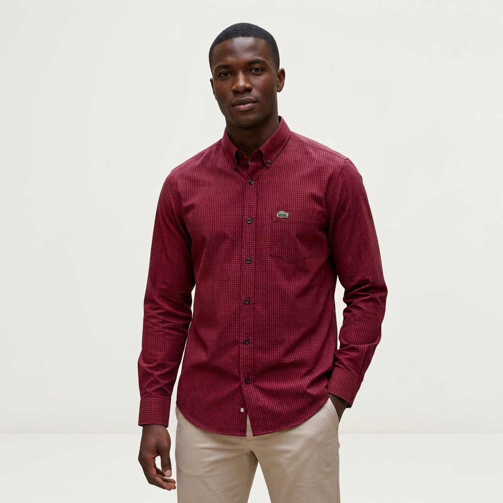 Male model wearing a burgundy micro-check long-sleeve shirt against a plain off-white background