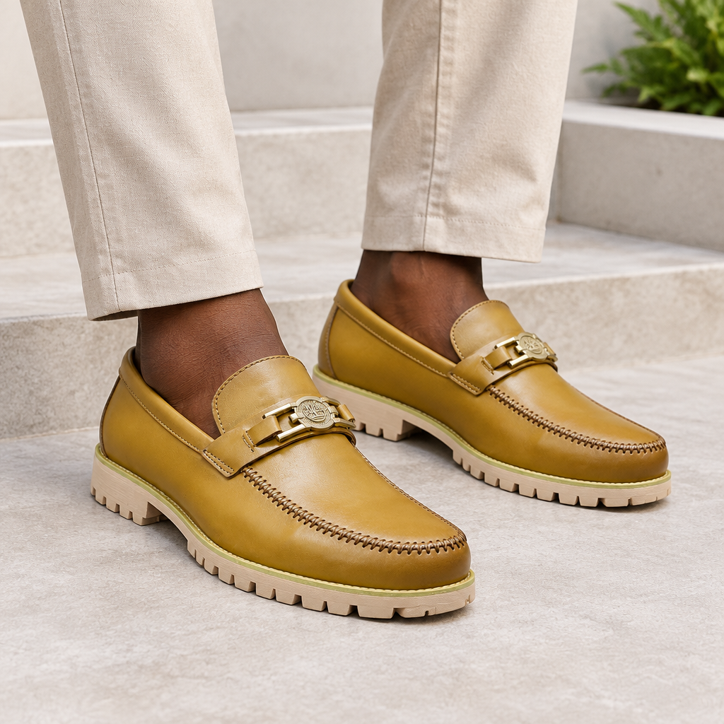 Black model wearing tan men's metal-detail penny loafers
