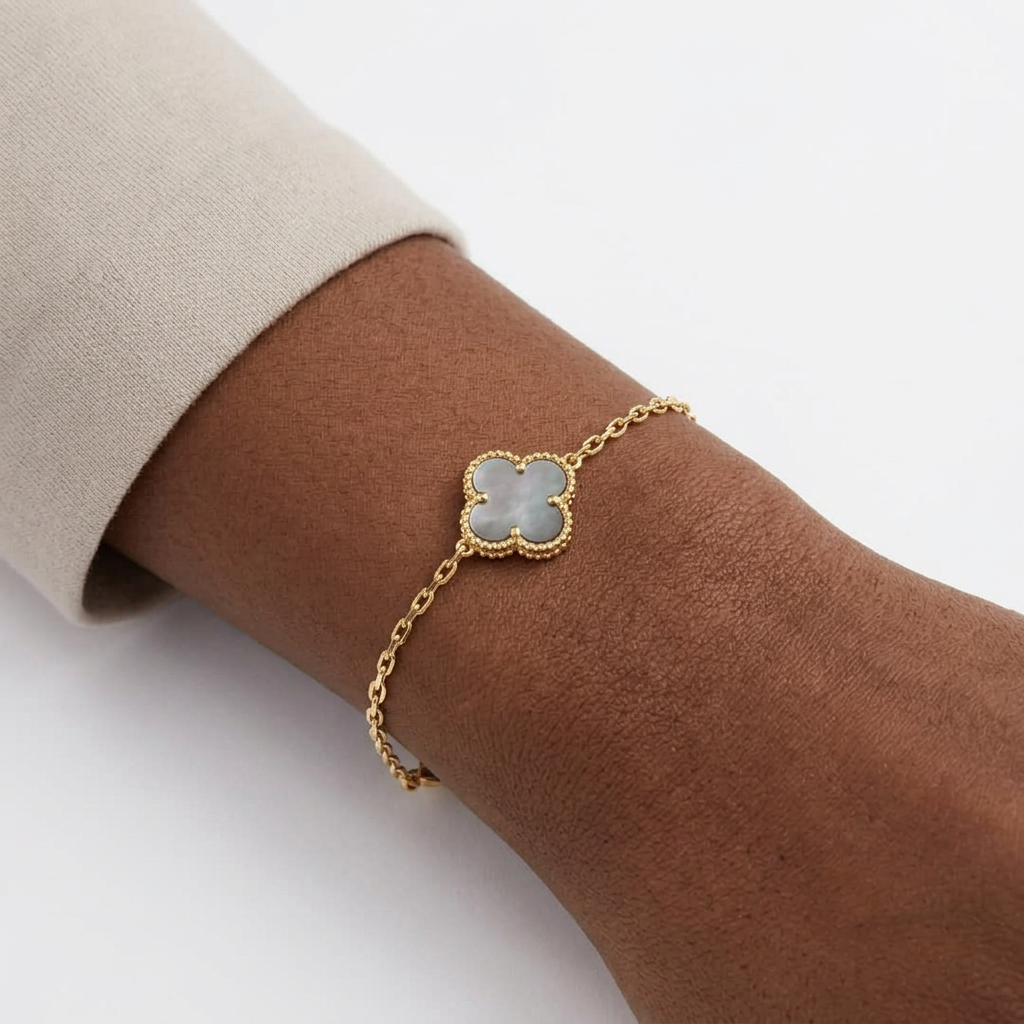 Single grey iridescent clover bracelet on a Black adult wrist