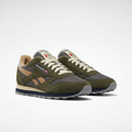 Pair of olive grey and tan mesh retro sneakers on white