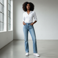 Nigerian female model wearing light blue bootcut high-waist jeans front view