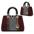 Burgundy and silver embellished top-handle bag front and visible side views on white