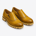 Golden-brown men's brogue slip-on shoes shown as a complete pair