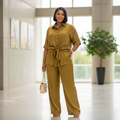 Nigerian woman wearing mustard satin tie-front shirt and trouser co-ord set