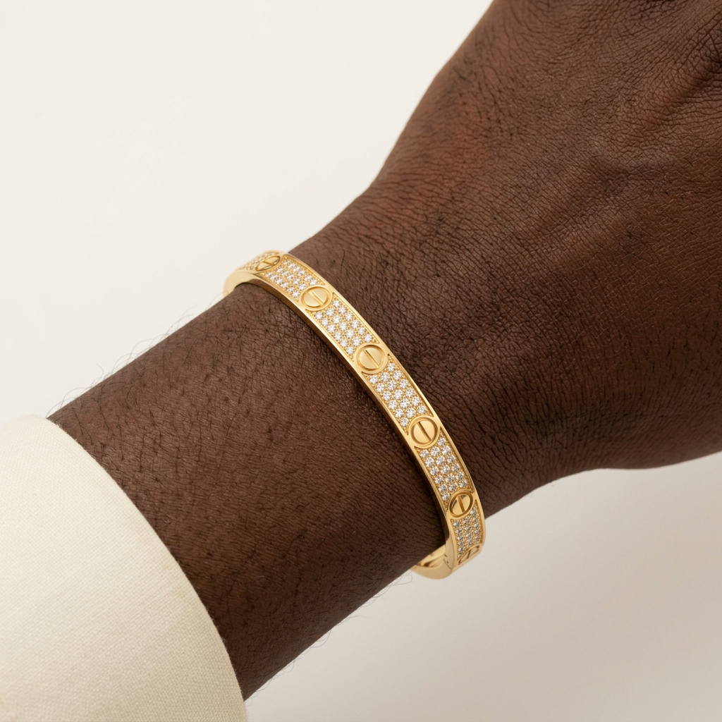 Gold-tone stone-set bracelet worn on a male model’s wrist