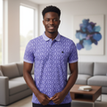 Young Nigerian male model wearing purple floral print polo shirt, front view