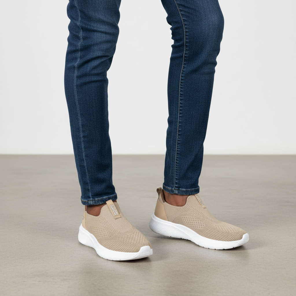 Beige knit slip-on sneakers with white sole worn with dark jeans