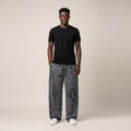 Model wearing grey leopard print baggy joggers with a black t-shirt