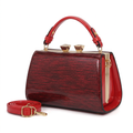 Ruby textured twin-clasp frame handbag and red shoulder strap on white