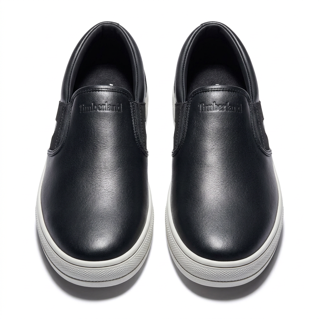 Black slip-on sneaker pair with elastic side panels and white soles
