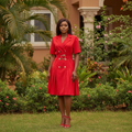 Women's bold red double-breasted gold button belted blazer dress - model shot