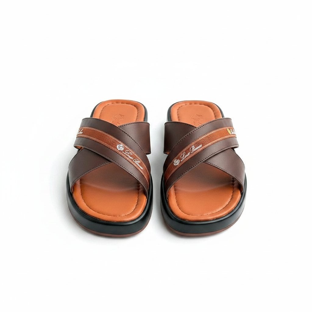 Men's dark chocolate brown leather cross-strap slide sandals with woven ribbon detail and gold badge, tan cognac footbed with contrast stitching, ghost mannequin pair view on white background