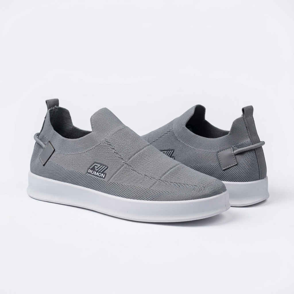Pair of grey knit panelled slip-on sneakers on white