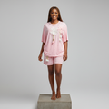 Nigerian female model front view - pink daisy appliqué rhinestone top and shorts set