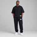 Nigerian male model wearing black oversized t-shirt and jogger tracksuit set