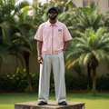 Nigerian male model wearing pink pinstripe zip-up varsity shirt – full body lifestyle shot