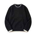 Black textured crew-neck knit sweater with white edging at neck cuffs and hem