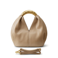 Warm-cream rounded handbag without label with gold-tone handle and matching strap on white