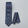 Navy medallion-pattern tie and matching pocket square on a neutral background