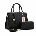 Black structured handbag and matching zip purse on white background