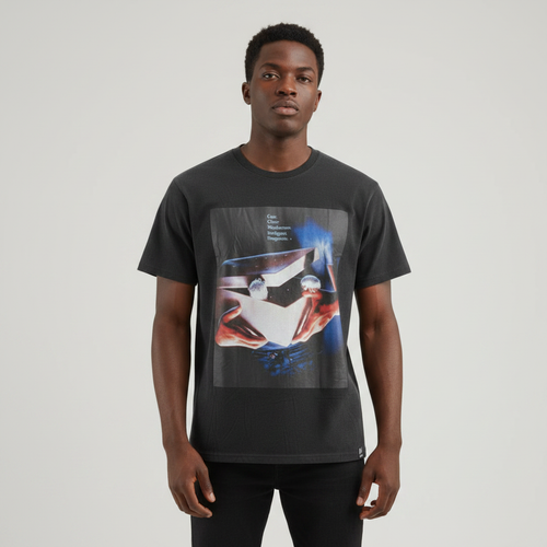 Young Nigerian male wearing washed black Gremlins vintage movie poster graphic crew neck tee