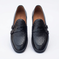 Straight-on black crocodile-effect loafers with twin dark buckles