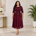 Black Nigerian woman wearing burgundy sparkle peplum occasion dress