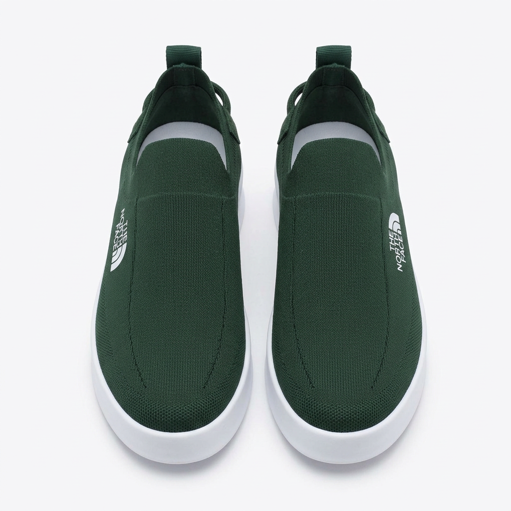 Straight-on dark green slip-on sneakers with textured uppers and white soles